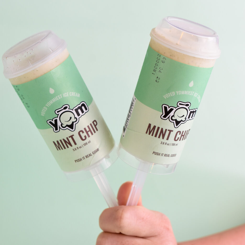 hand holding two mint chip push pops