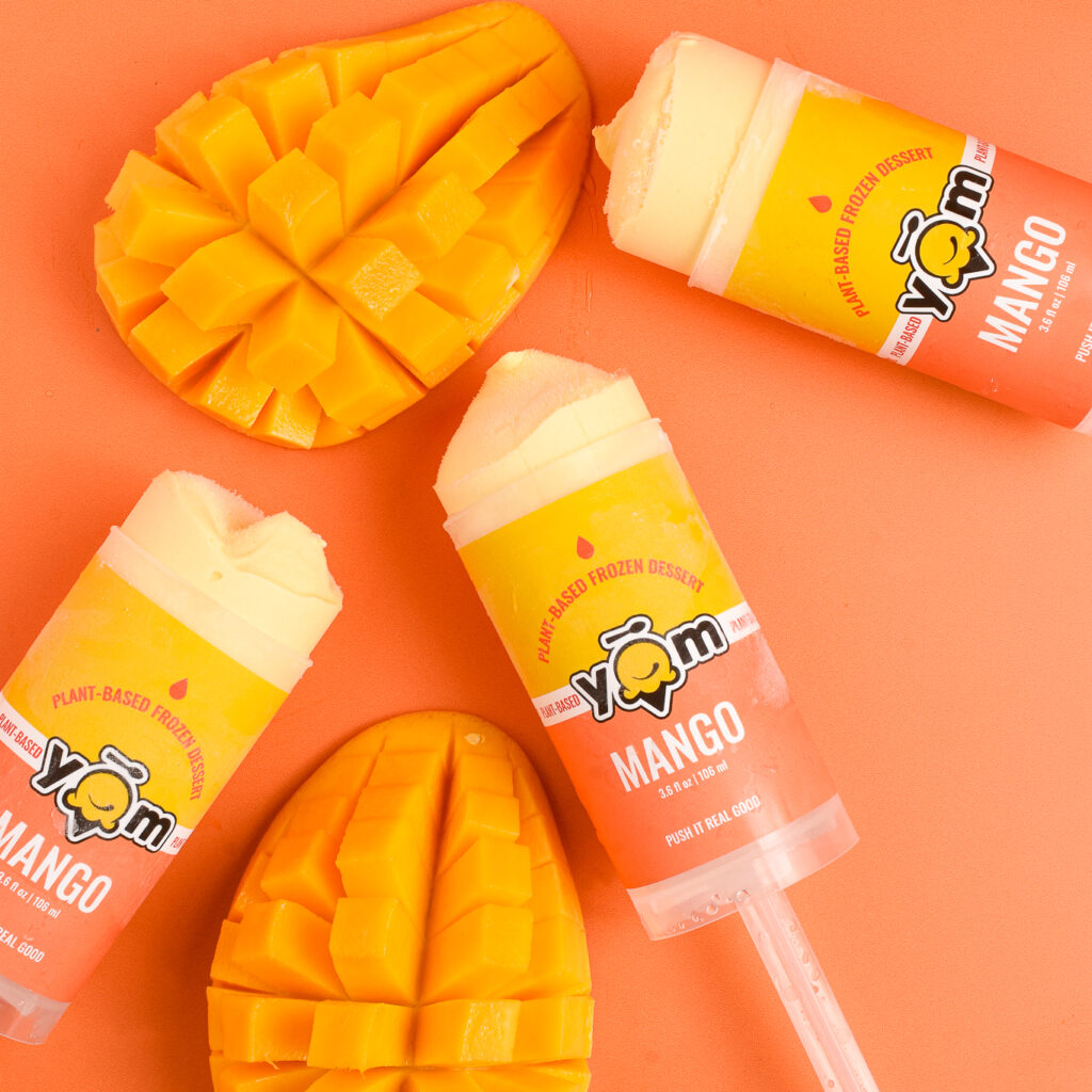 mango ice cream push pops with sliced mangos